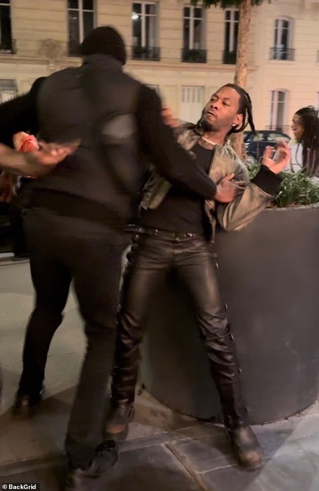 92085741-14084227-Offset_was_seen_being_held_back_as_a_huge_street_brawl_erupted_i-a-2_1731614837530.jpg