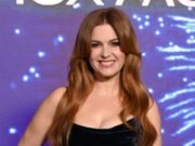 Isla Fisher hace una exhibición glamorosa con un vestido de terciopelo negro con un corpiño de encaje transparente en el photocall Now You See Me: Now You Don’t.